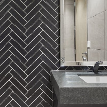 Concerto Black Matte Herringbone Pattern Glazed Porcelain Tile In A Commercial Bathroom from Arizona Tile