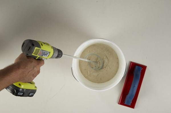 Mixing Grout in a Bucket with a Drill Mixer