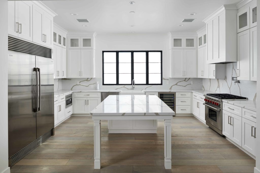 Newly remodeled kitchen with Bianco Levanto Quartz counters and backsplash - Fairmount Development Design using Arizona Tile