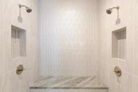 Dunes Wave Pearl Bathroom Shower Tile, Cosmic White Wall Tile, and Fantasy Blue Satin Bench Slab from Arizona Tile